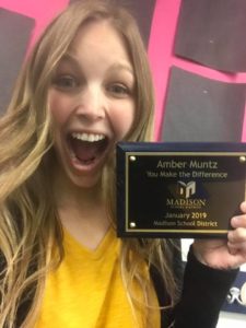 Amber Muntz ’14 posing with her You Make A Difference award